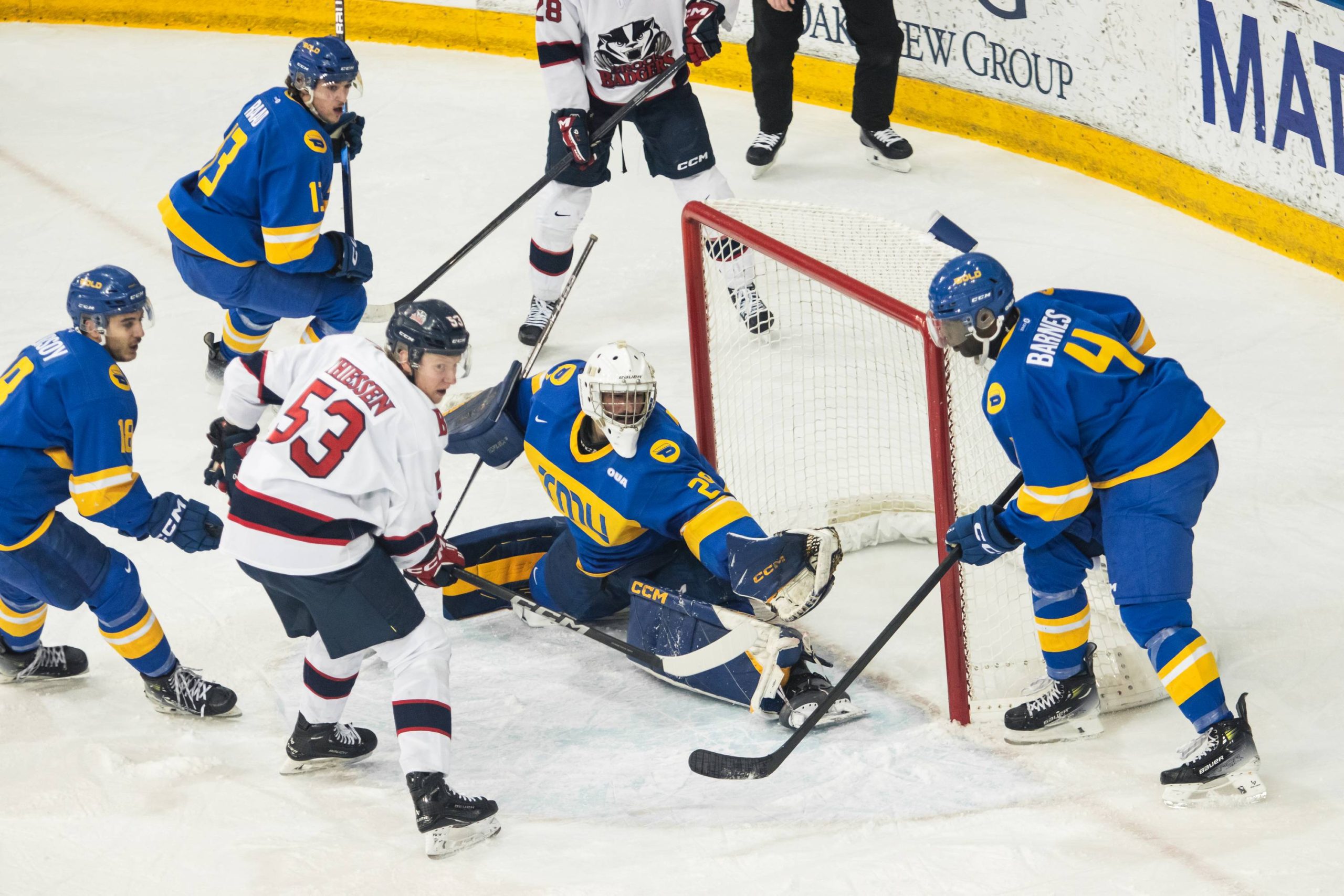 Ryan Dugas stretches to make a glove save across his goal crease