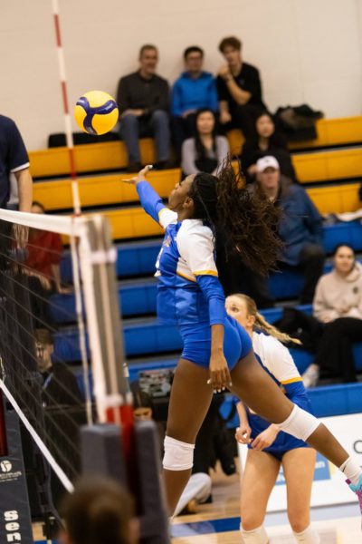 Rayanna Amos-Ross Fisher hitting the ball in a block