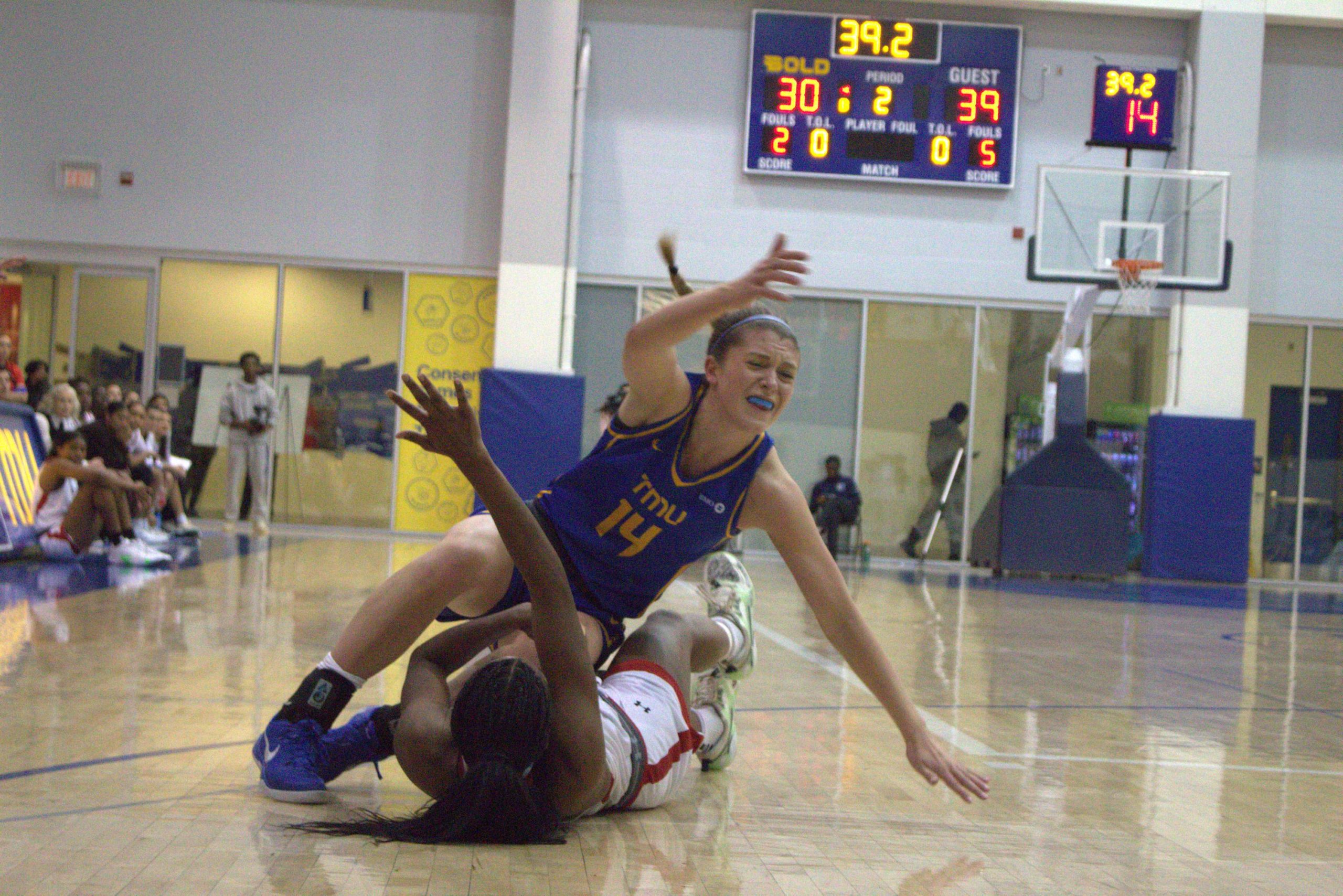 Kaillie Hall disputing the ball against a Carleton player