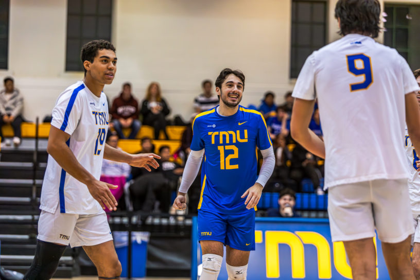 Three TMU Bold players celebrating a point