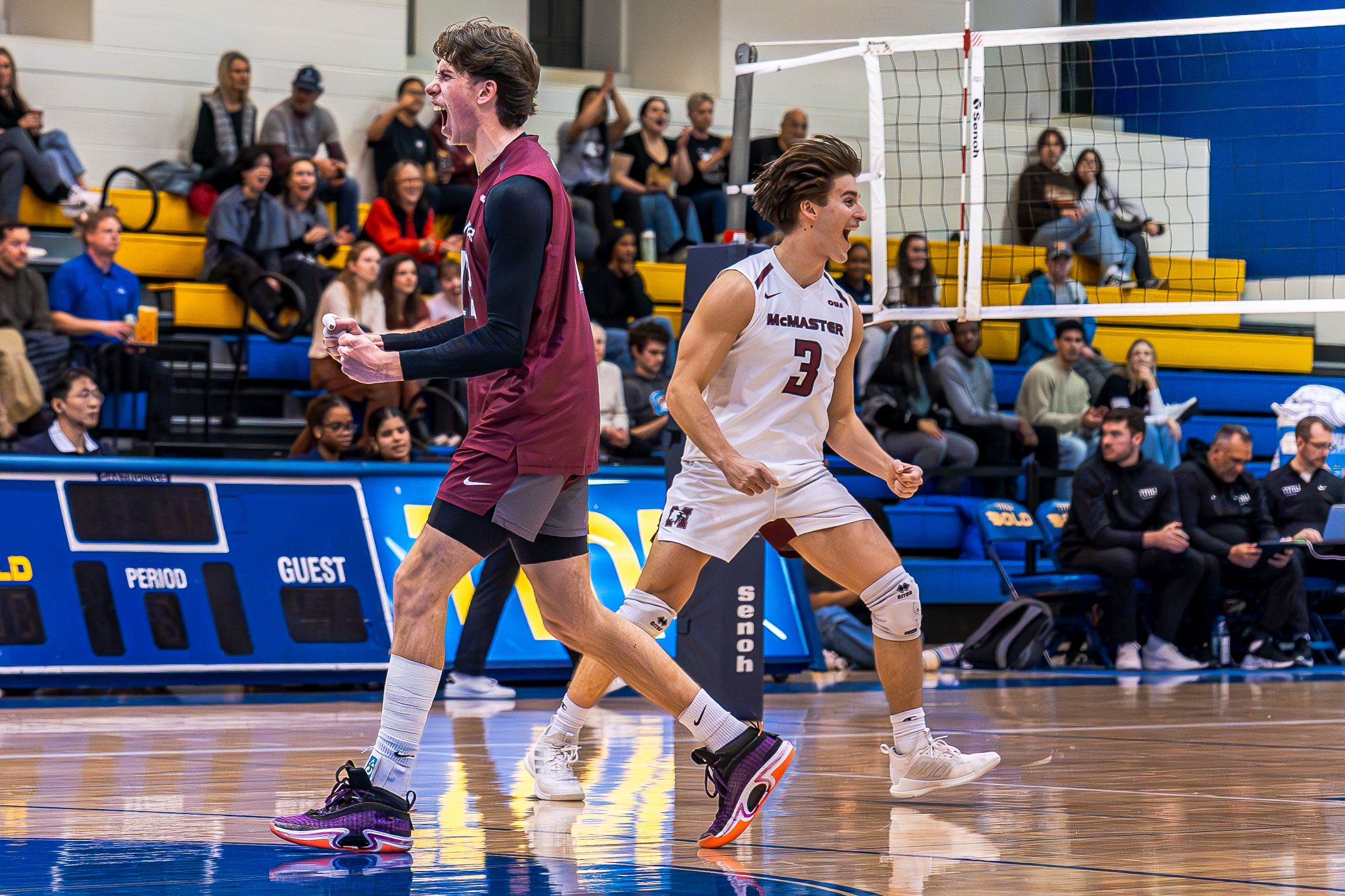 Two McMaster players celebrating a point