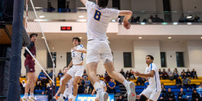 Riley Donovan jumping to spike the ball