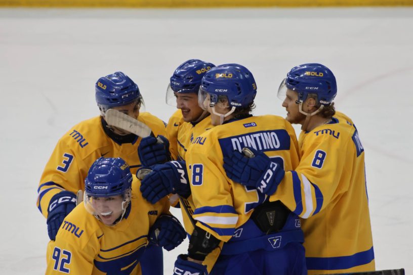 The TMU Bold men's hockey team celebrating a goal