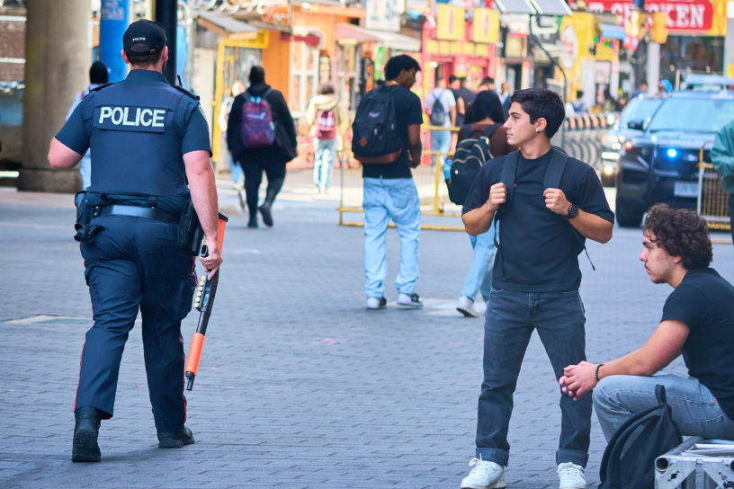 police walking past students