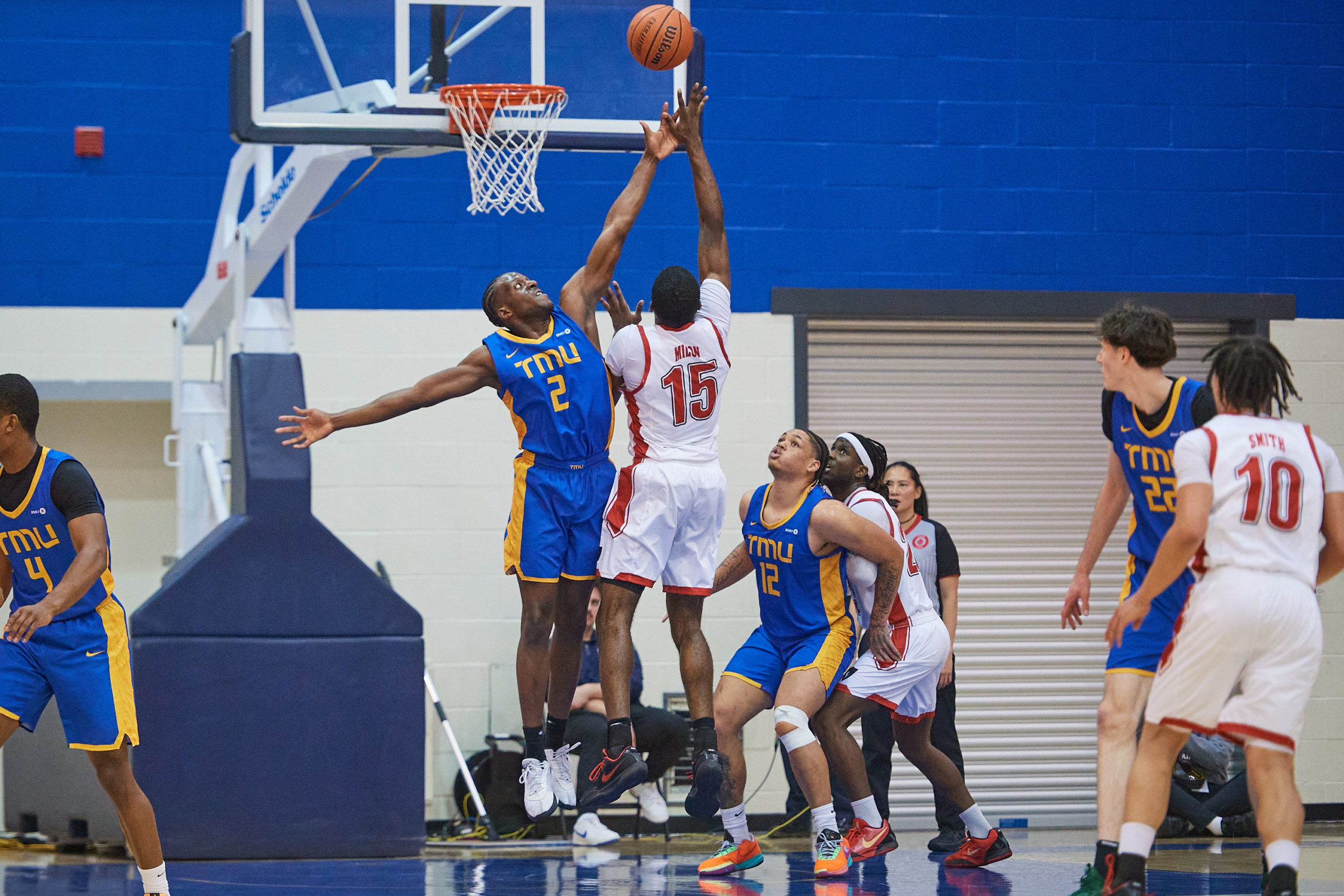 Galand Okeugo goes up for a block against a Carleton player