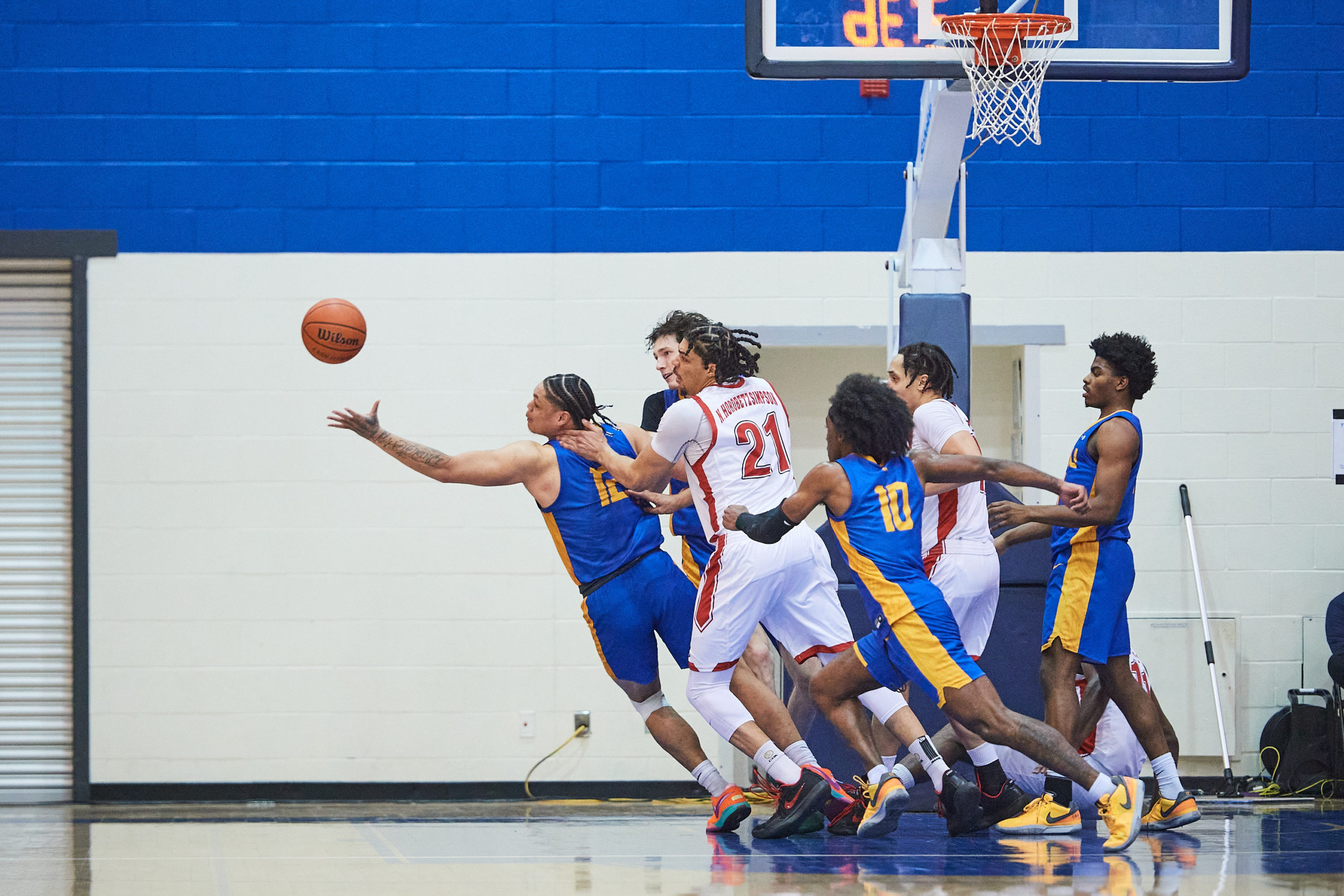 Aaron Rhooms stretches to grab a ball out of the air from a pile of players