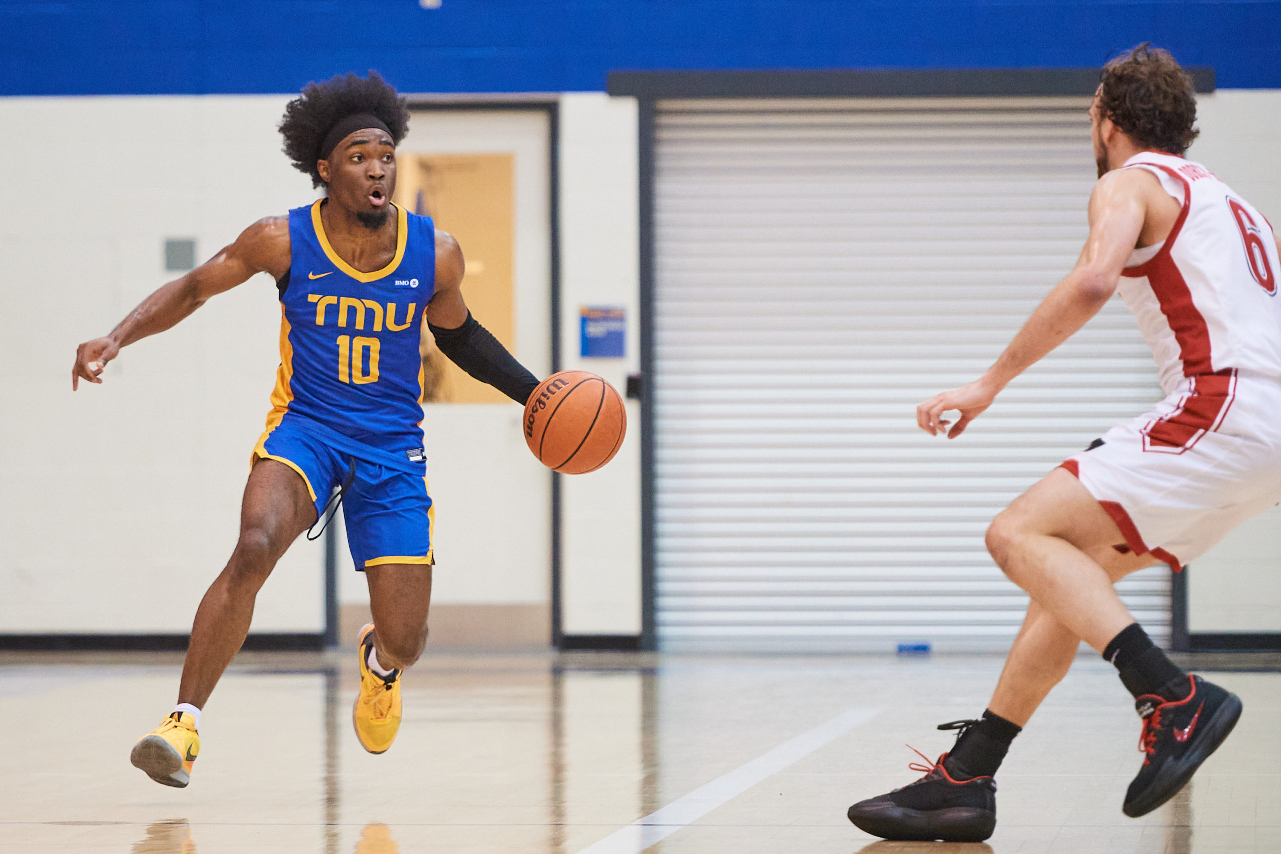 Javier Gilgeous-Glasgow dribbles a ball up to a Carleton Ravens defender