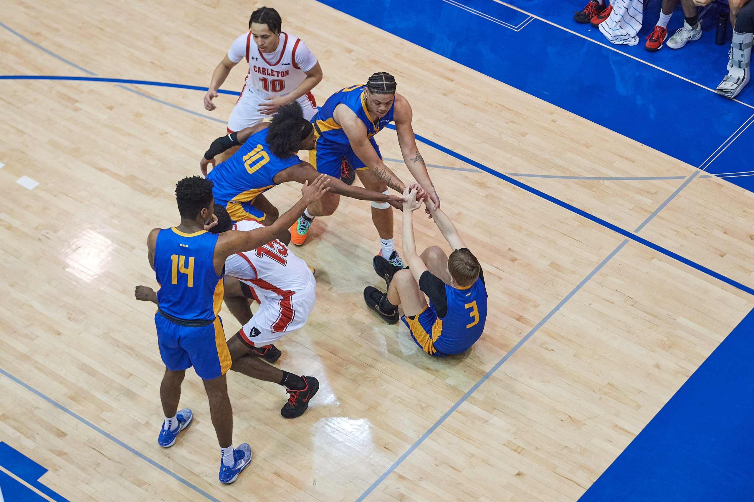 TMU players help Kevin Toth off the ground