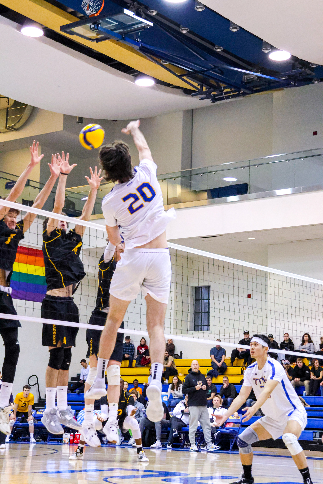 Alex King hitting the ball at the wall