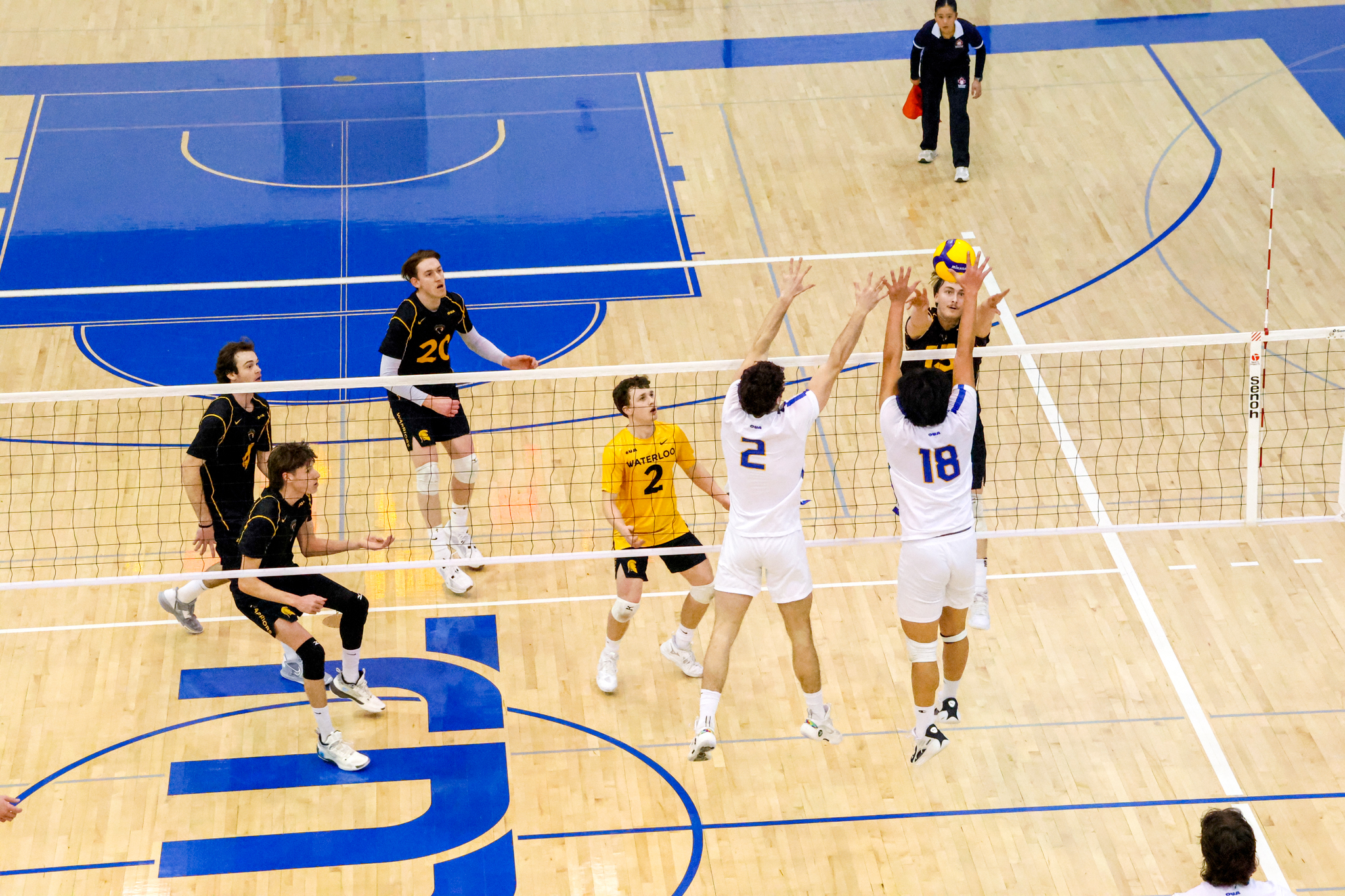 A Warriors player hitting the ball at the wall