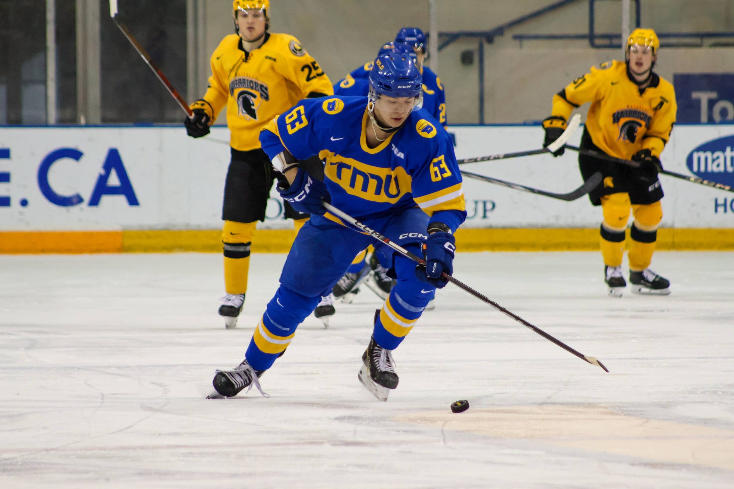 Liam Ross skating with the puck