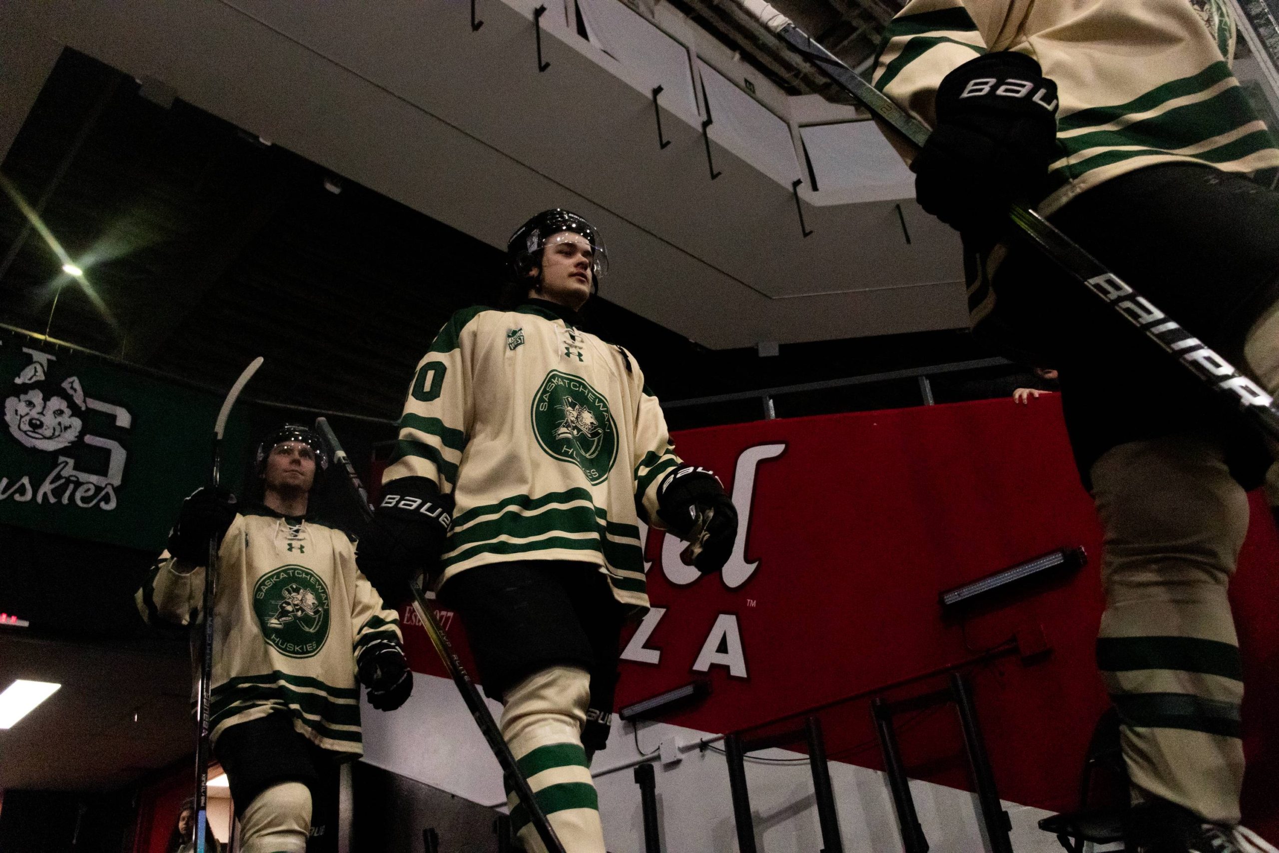 A huskie player coming into the rink