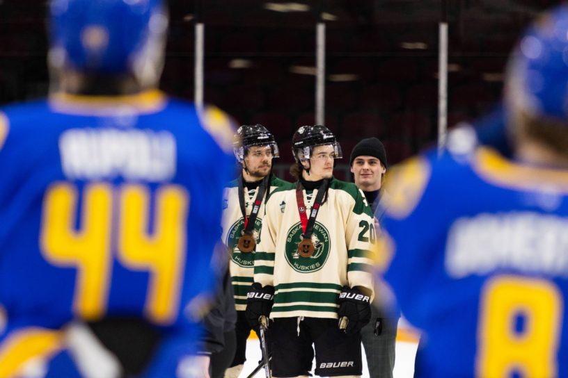 two Bold players looking at the bronze medal winners the huskies