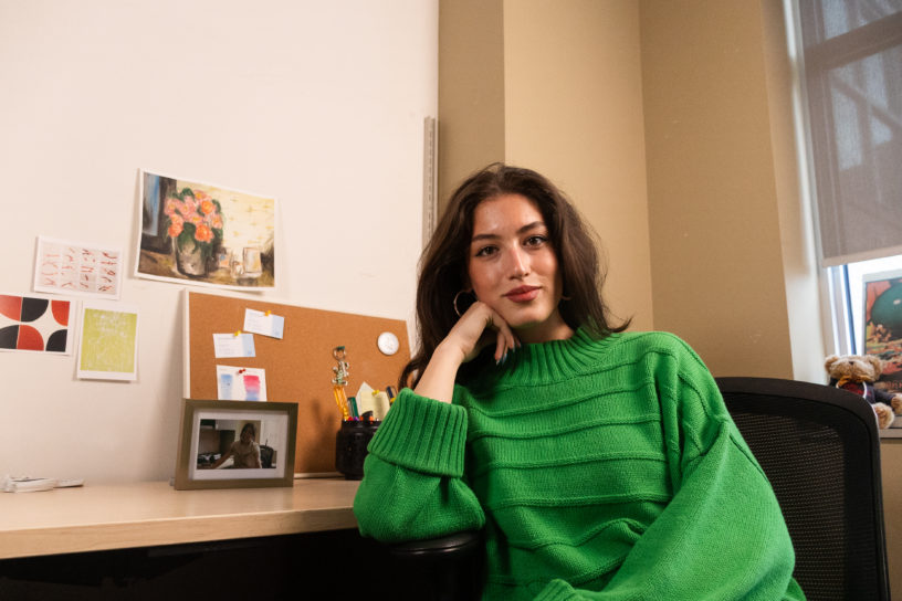 Image of Negin Khodayari in her office her resting head on her fist and looking at the camera