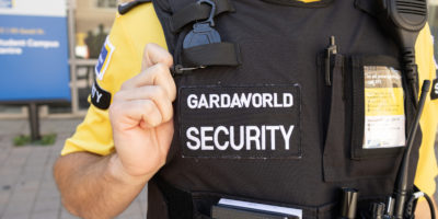 A TMU campus security guards vest with the GARDAWORLD logo on it.