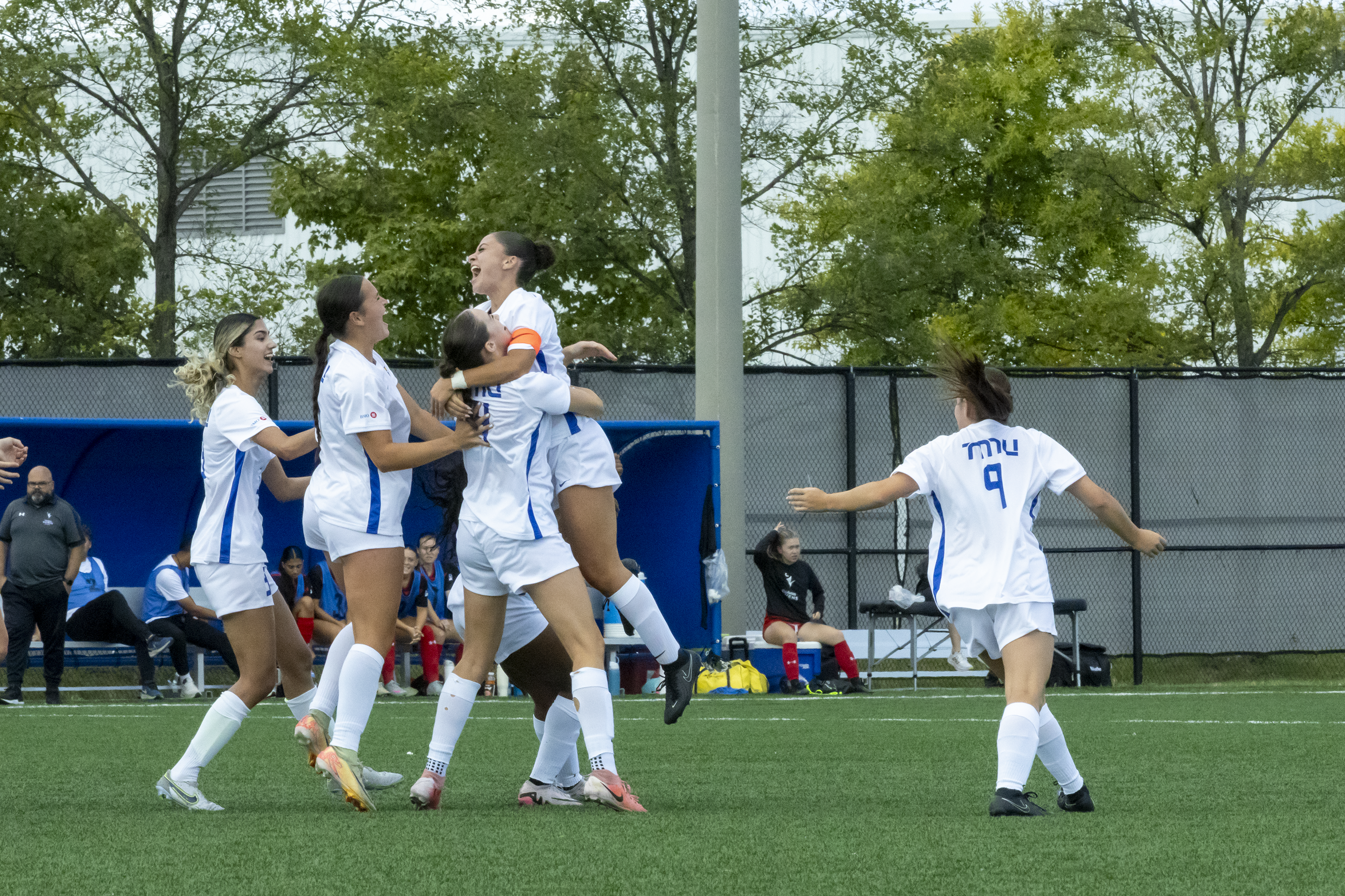 The TMU Bold women's soccer players celebrate a goal