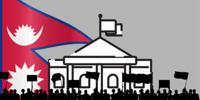 Composition of people protesting at a building with the Nepal flag on the far left.