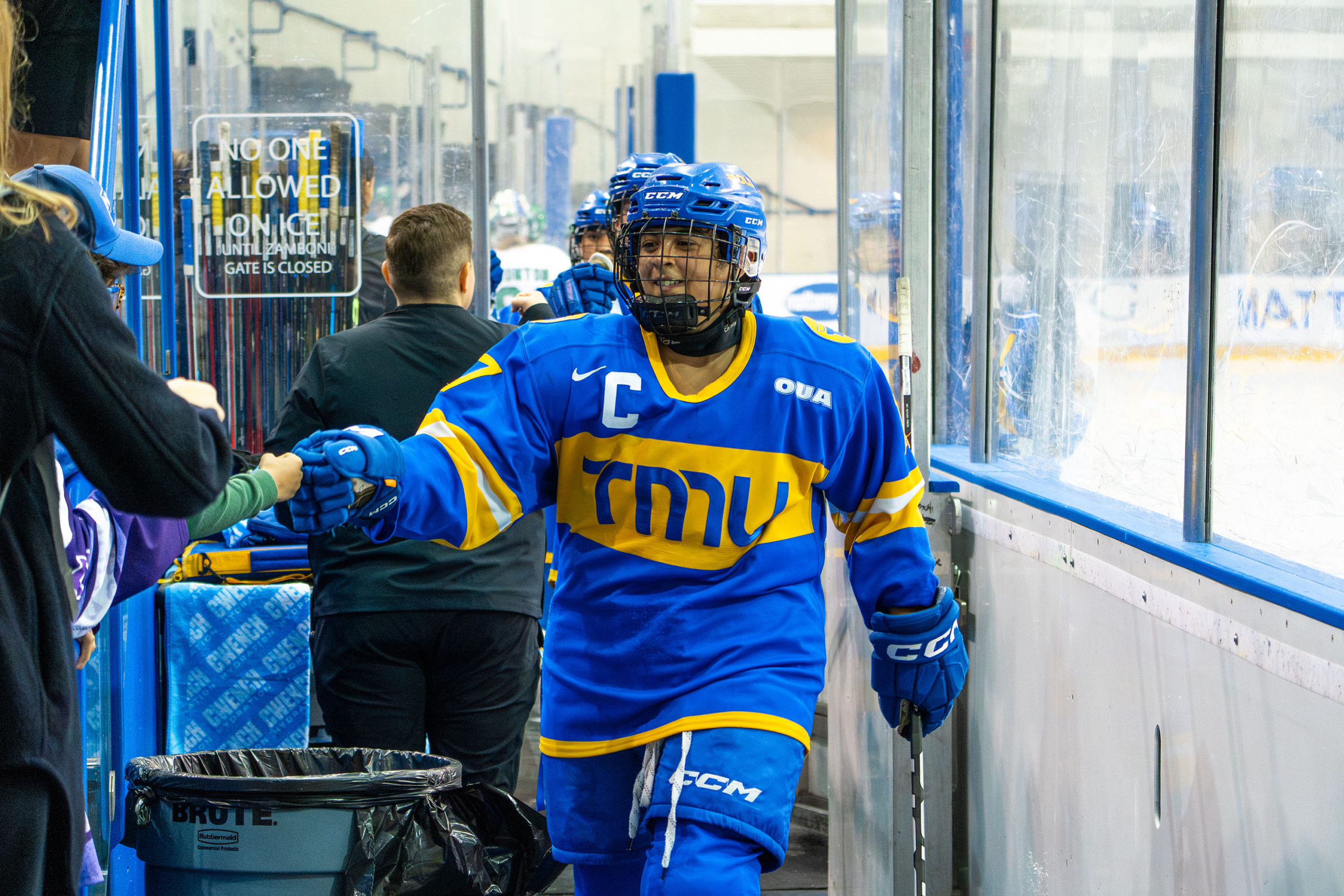 Cailey Davis high-fives someone while walking off the ice