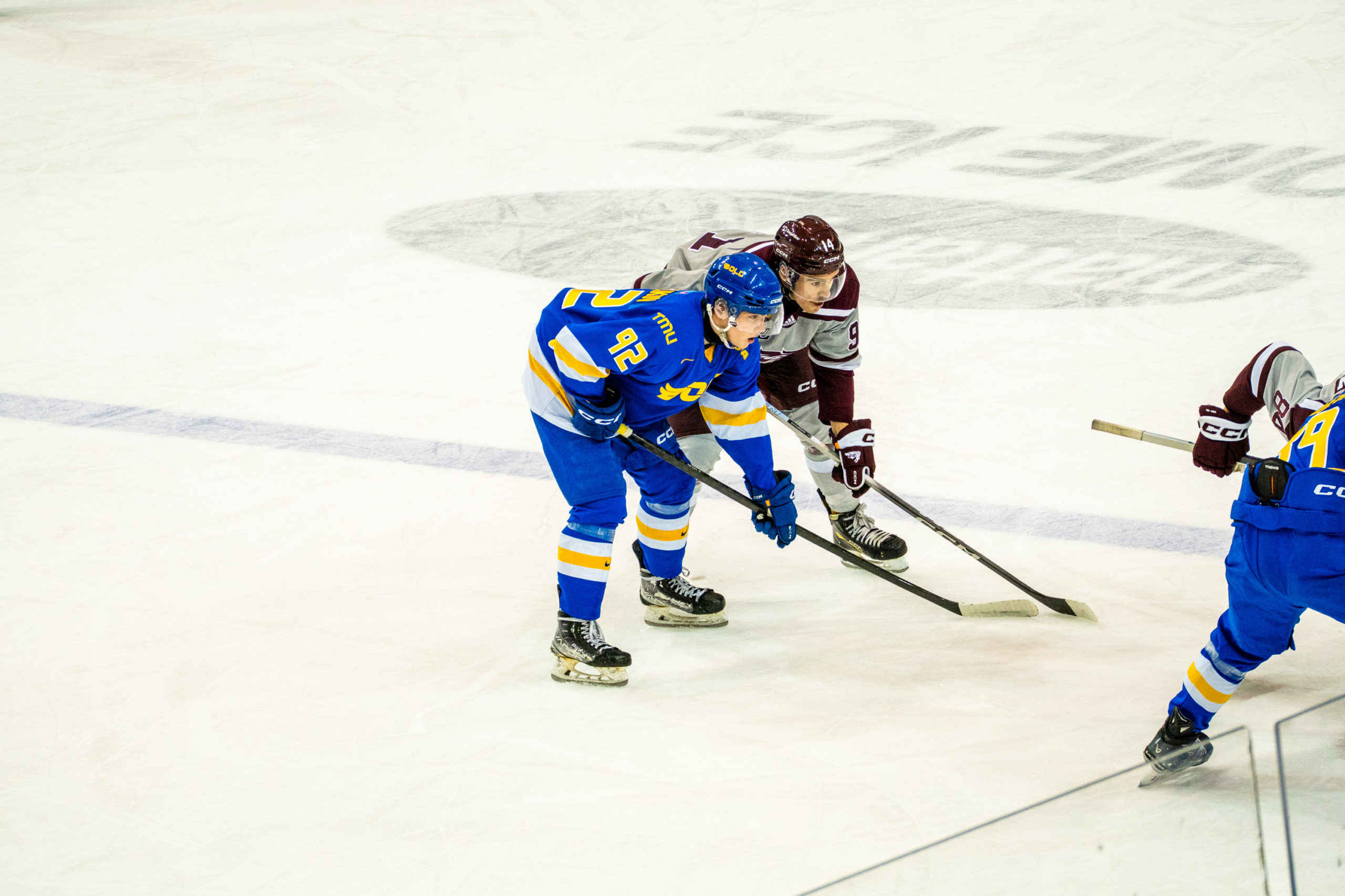 A TMU and Ottawa player meet at a face-off point