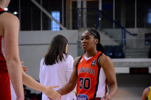 Shayeann Day-Wilson dapping up a teammate heading back to the bench