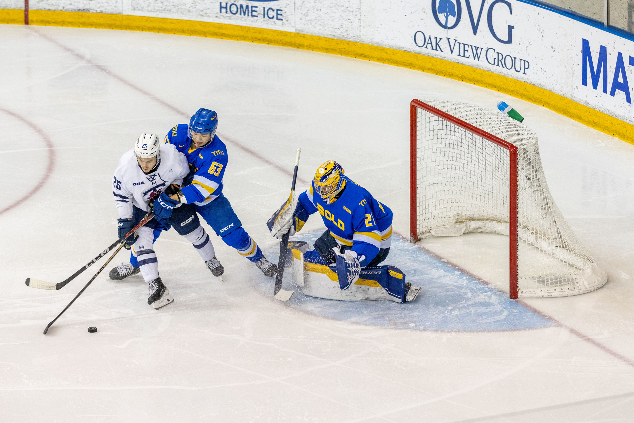 TMU defends their crease from a U of T player