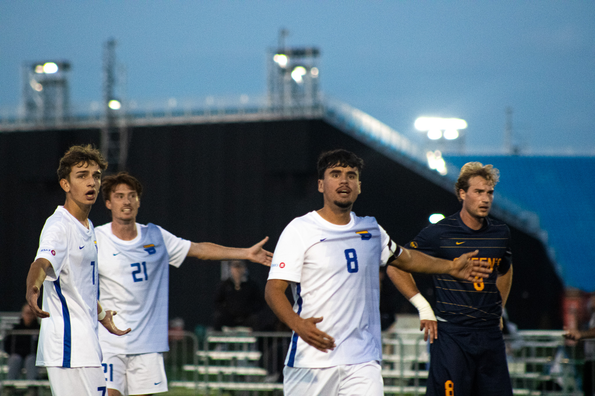 TMU Bold men's soccer team players argue with the referee