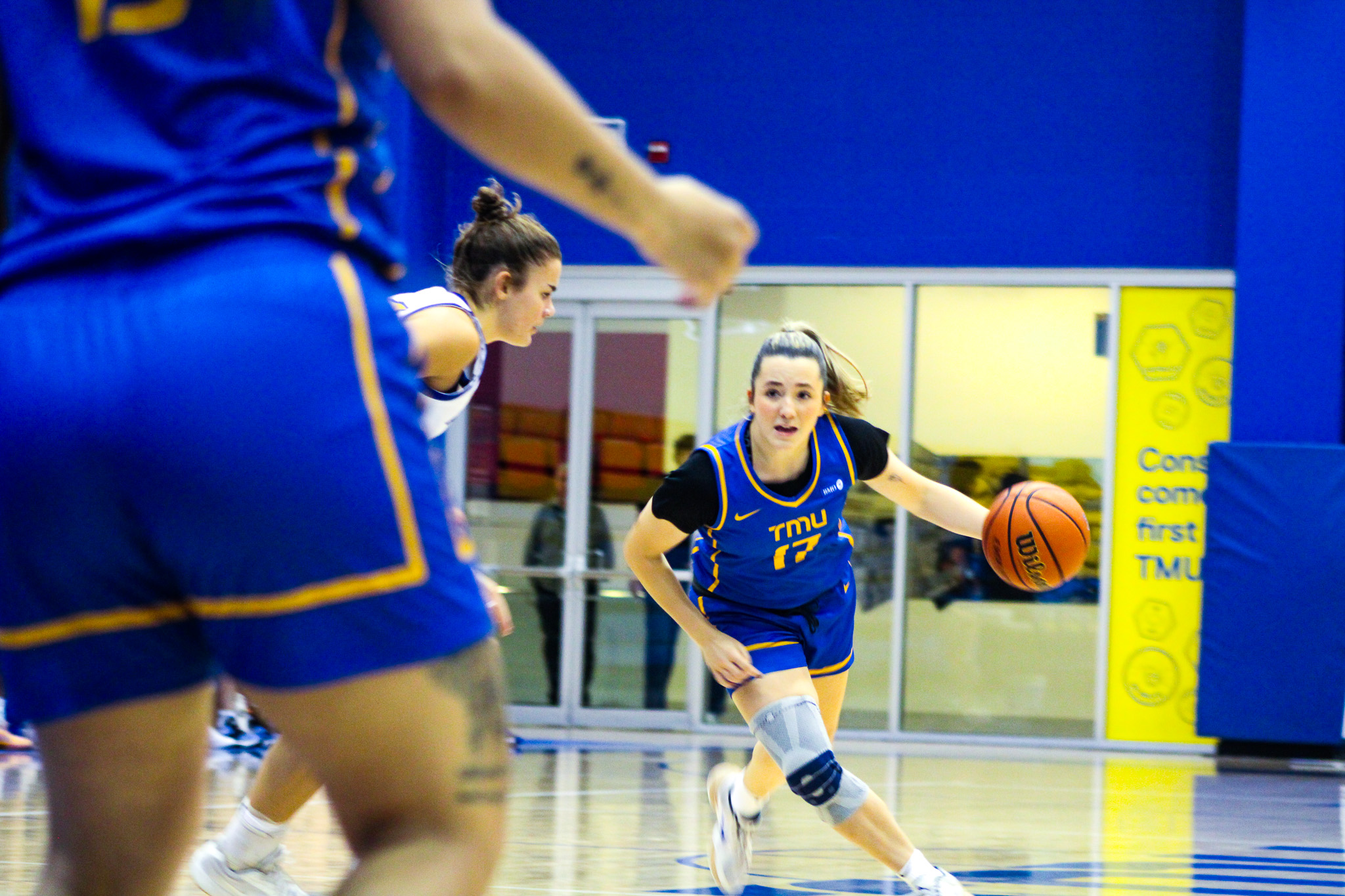 A TMU player dribbles the ball