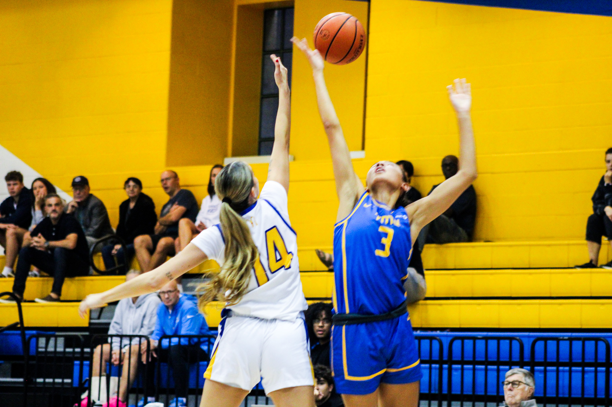 A TMU and UBC player battle for possession