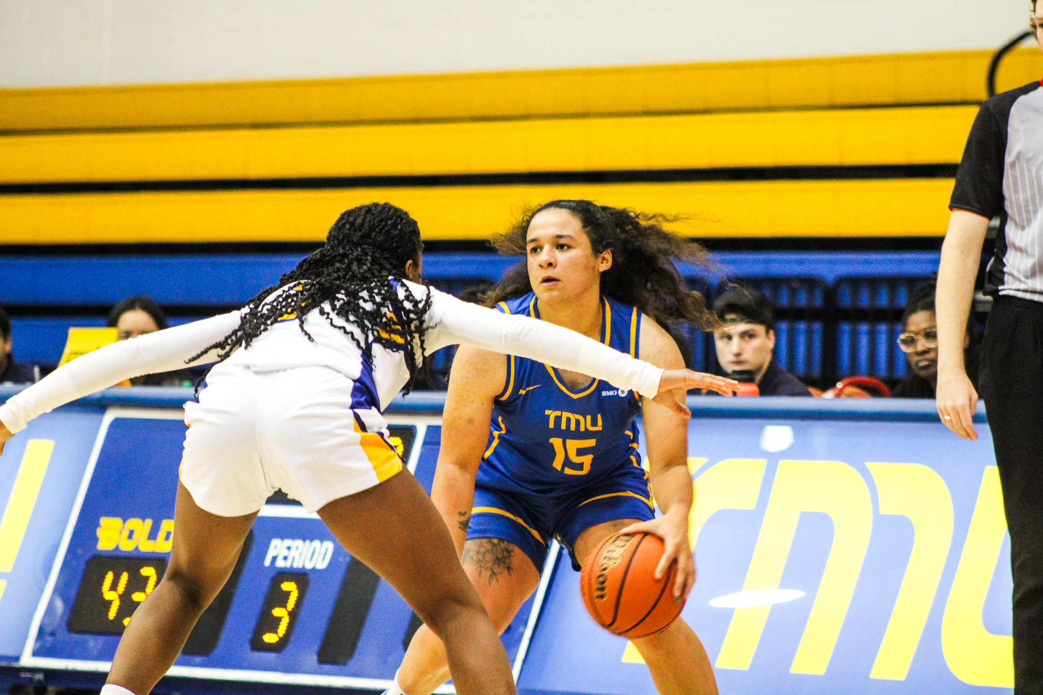 A TMU player has possession of the ball