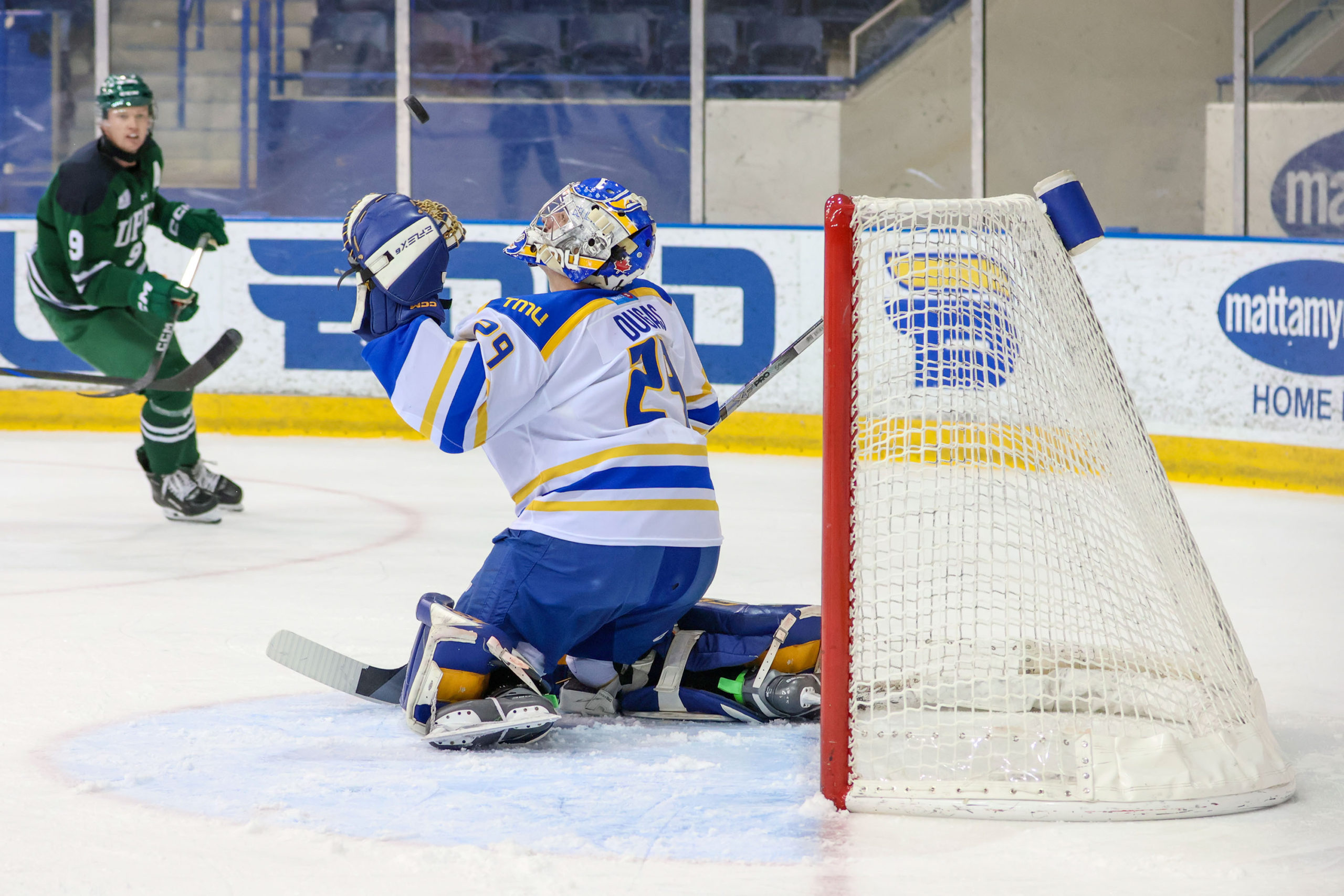 Ryan Dugas attempts to save the puck