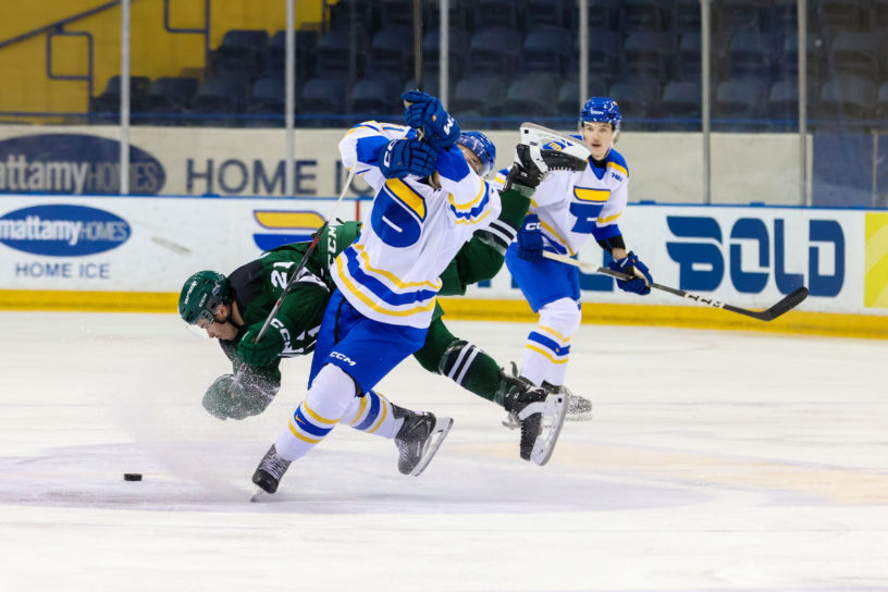 A TMU and UPEI player clash into each other