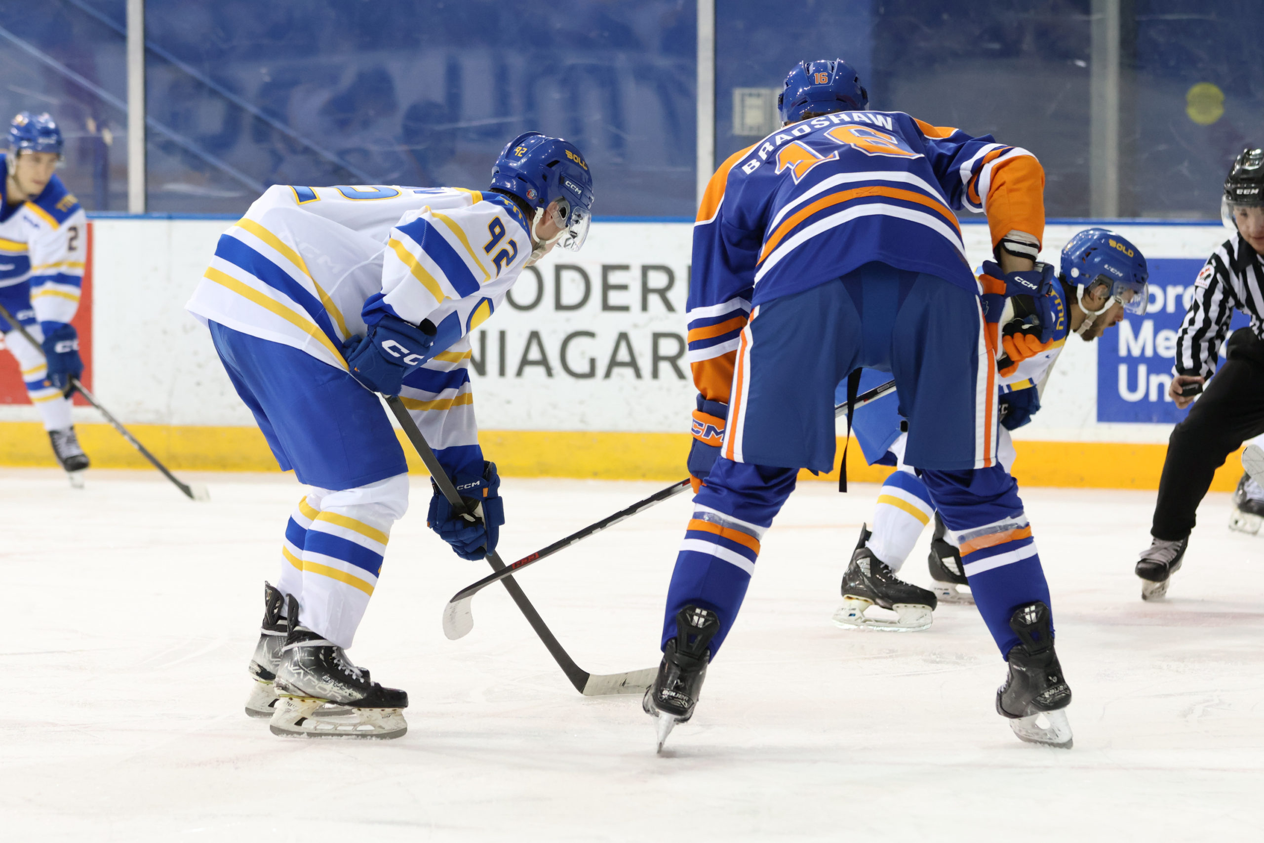 Two opposing players meet at a face-off point