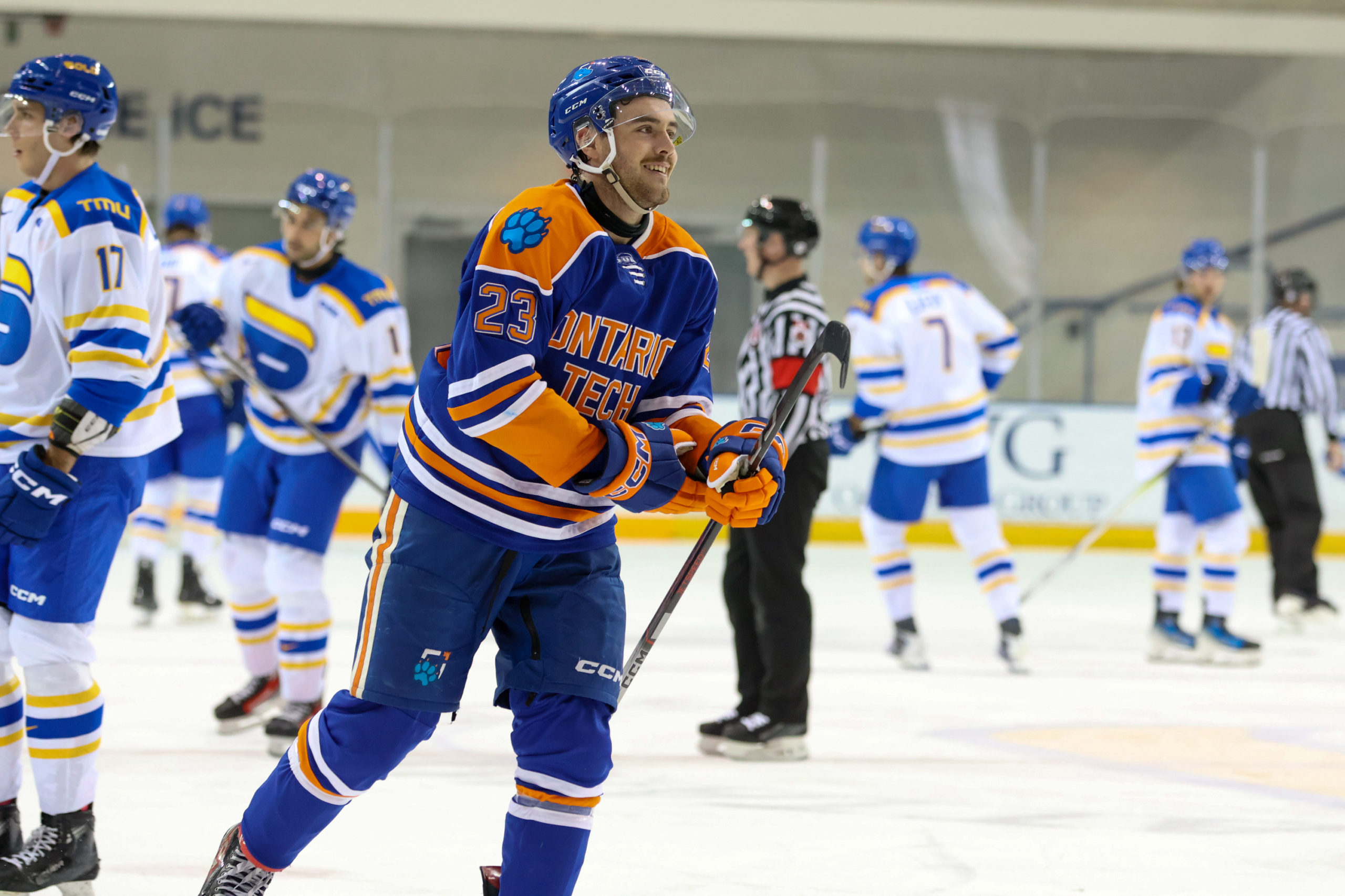 An Ontario Tech player smiles amidst TMU players