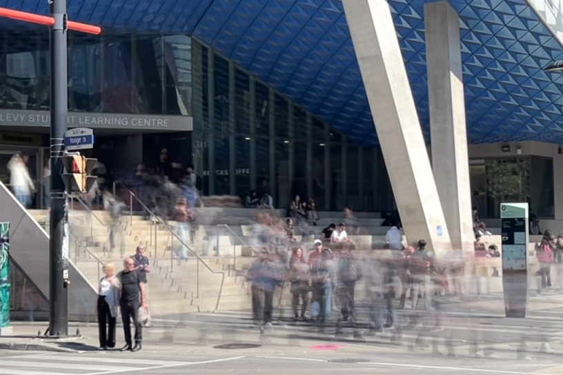 Picture of the Sheldon Levy Centre (SLC) with blurred people walking up and down the stairs.