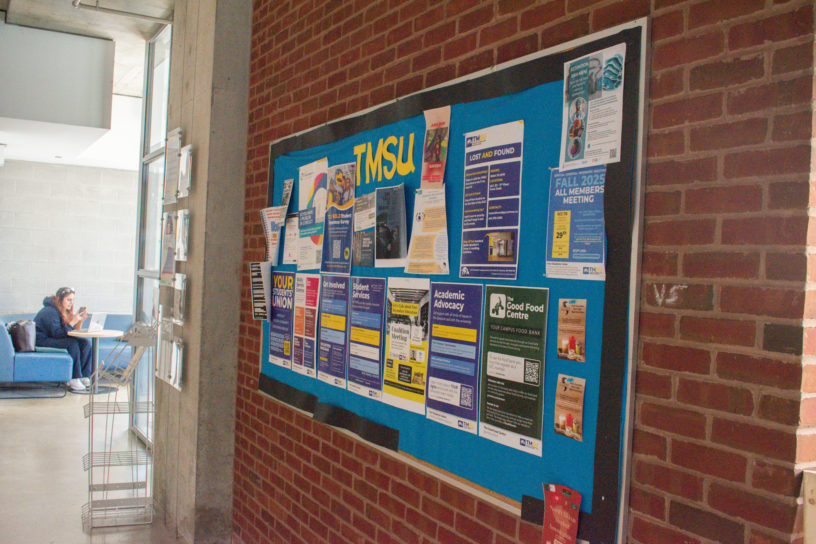 picture of a blue bulletin board with “TMSU” written on it in yellow.