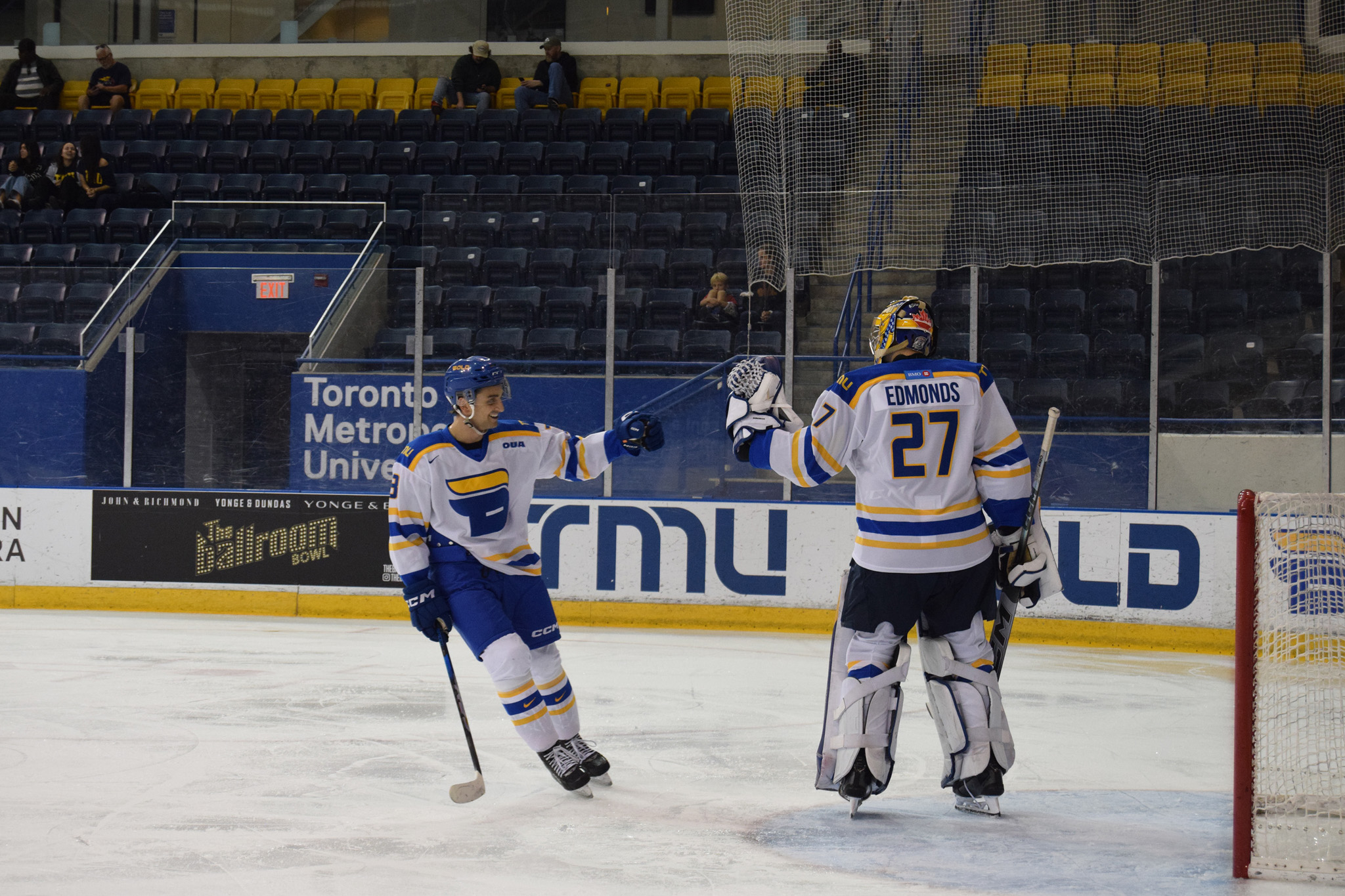 A TMU player goes up to high five their goaltender