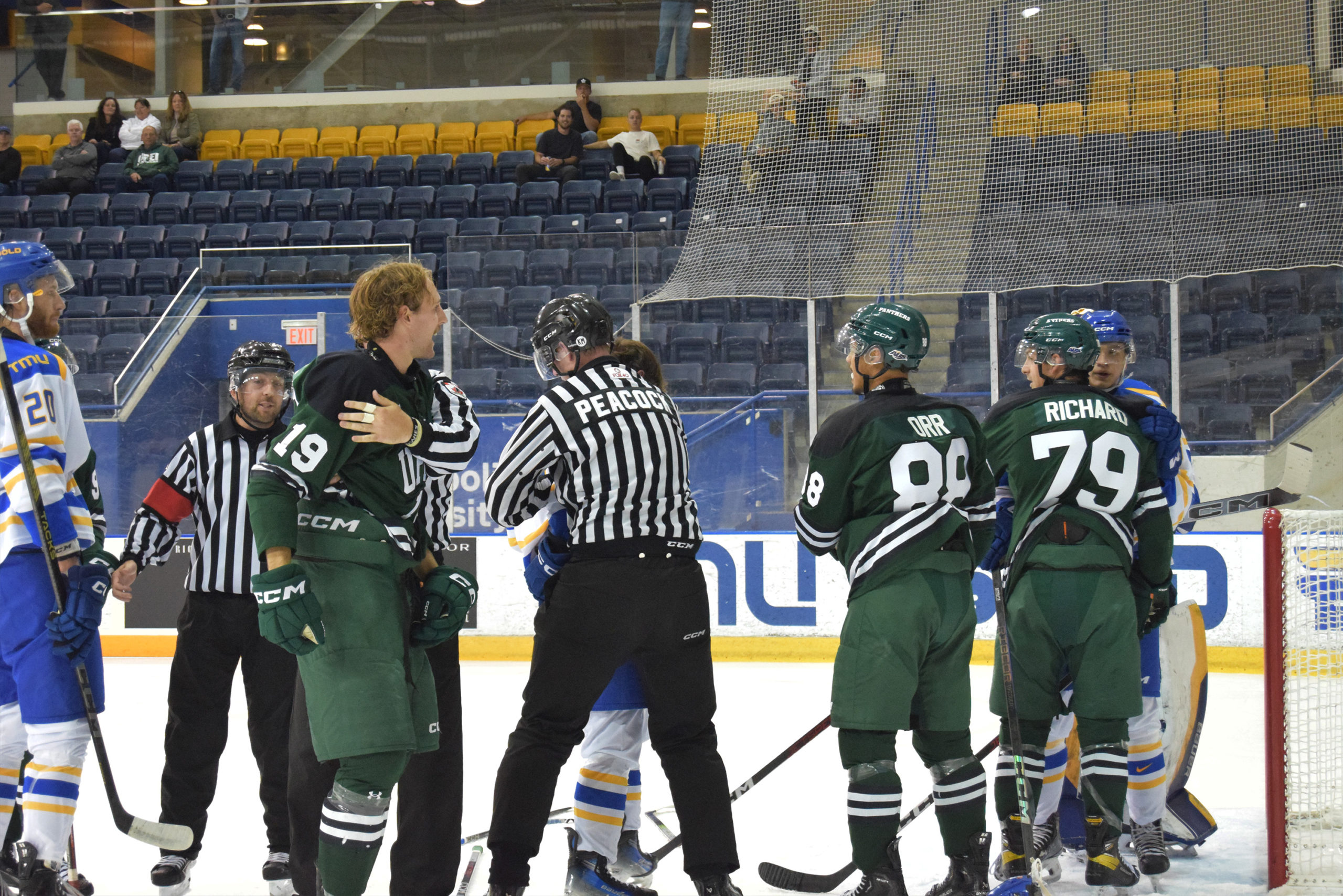 Referees try to break up UPEI and TMU players