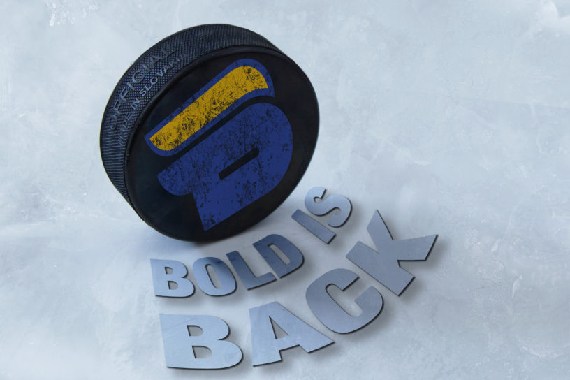 Photo illustration of a hockey puck with the bold logo on it, there is text below the puck saying "Bold is Back".