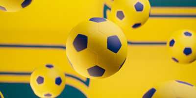 Illustration of yellow soccer balls floating around the frame.