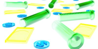 Test tubes, yellow rectangles and blue money chips spread out on a white background.
