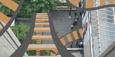 Illustration of rollercoaster tracks going around a birds eye view image of TMU campus.