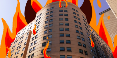Picture of pitman hall with illustrations of brown devil horns coming out of the sides, and red and orange flames coming out of the roof and the windows.