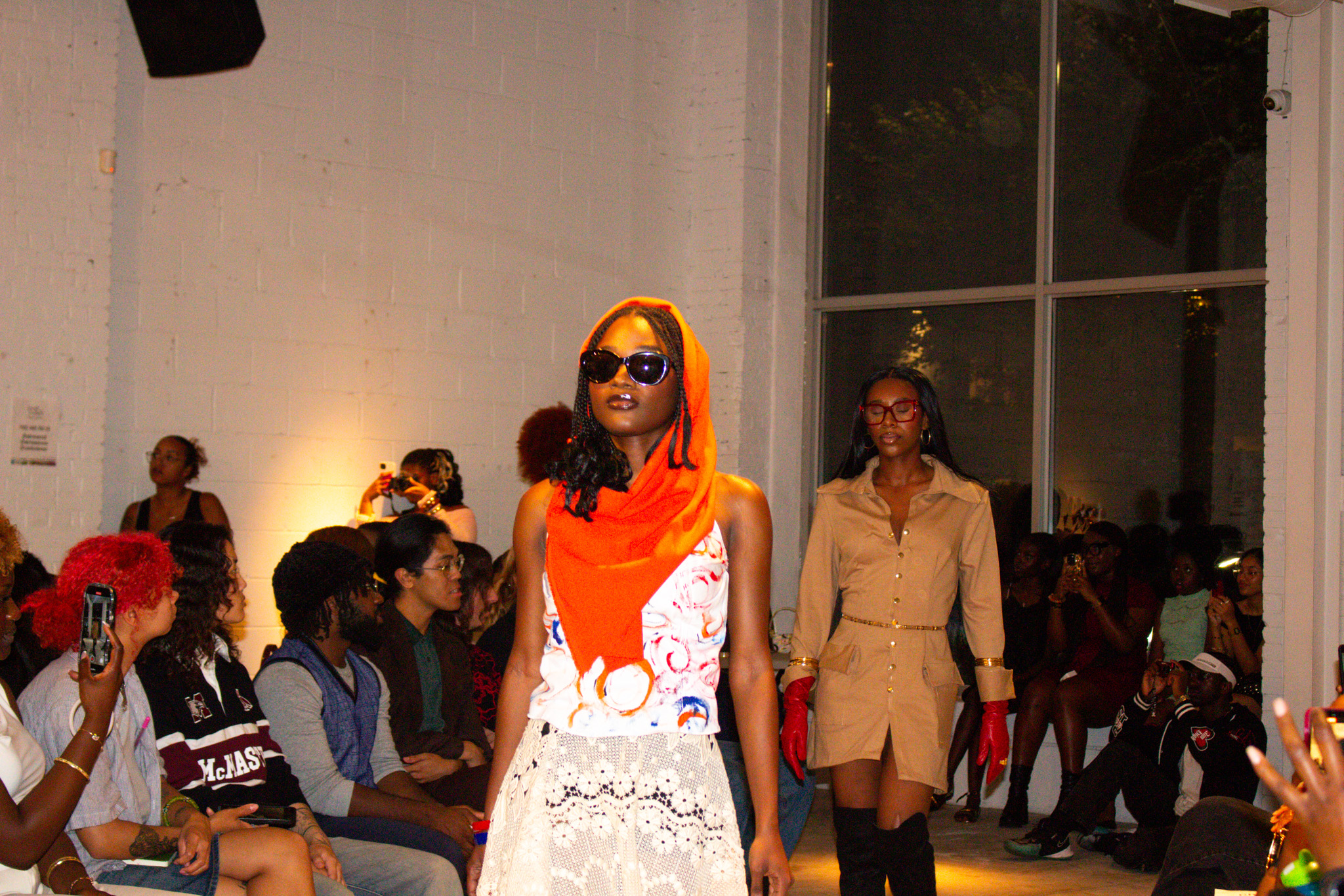 Two models walking on a runway.