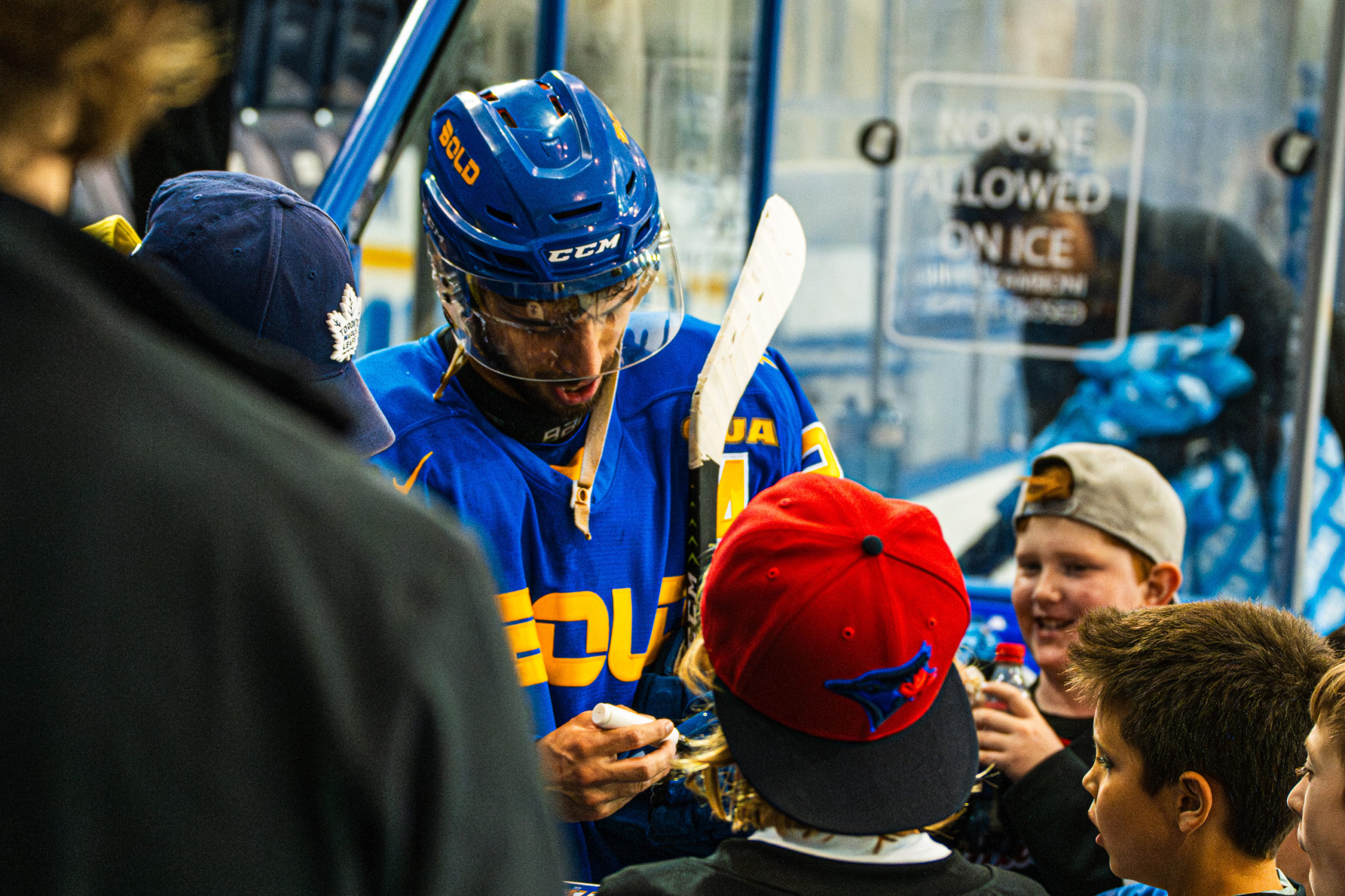 Aleks Dimovski autographs a photo for young guests