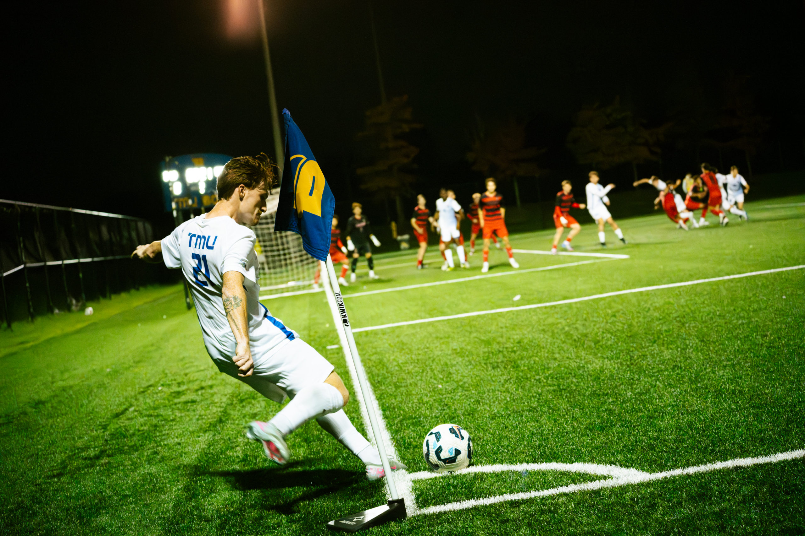 A TMU player kicks the ball back into the field