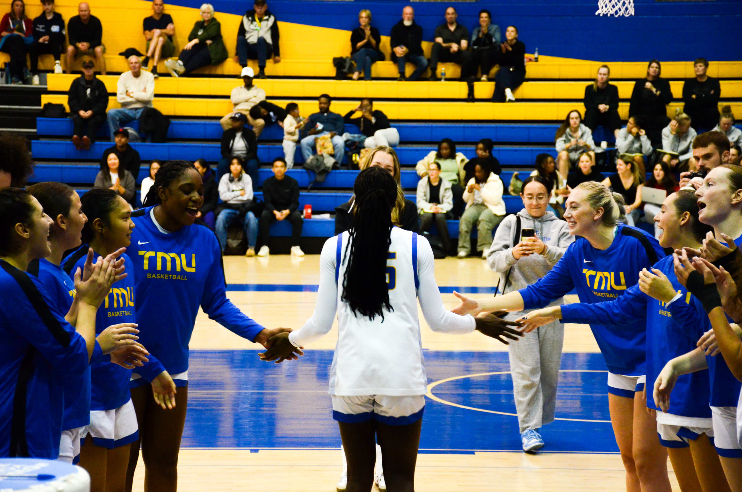 TMU's starting lineup makes their entrance onto the court