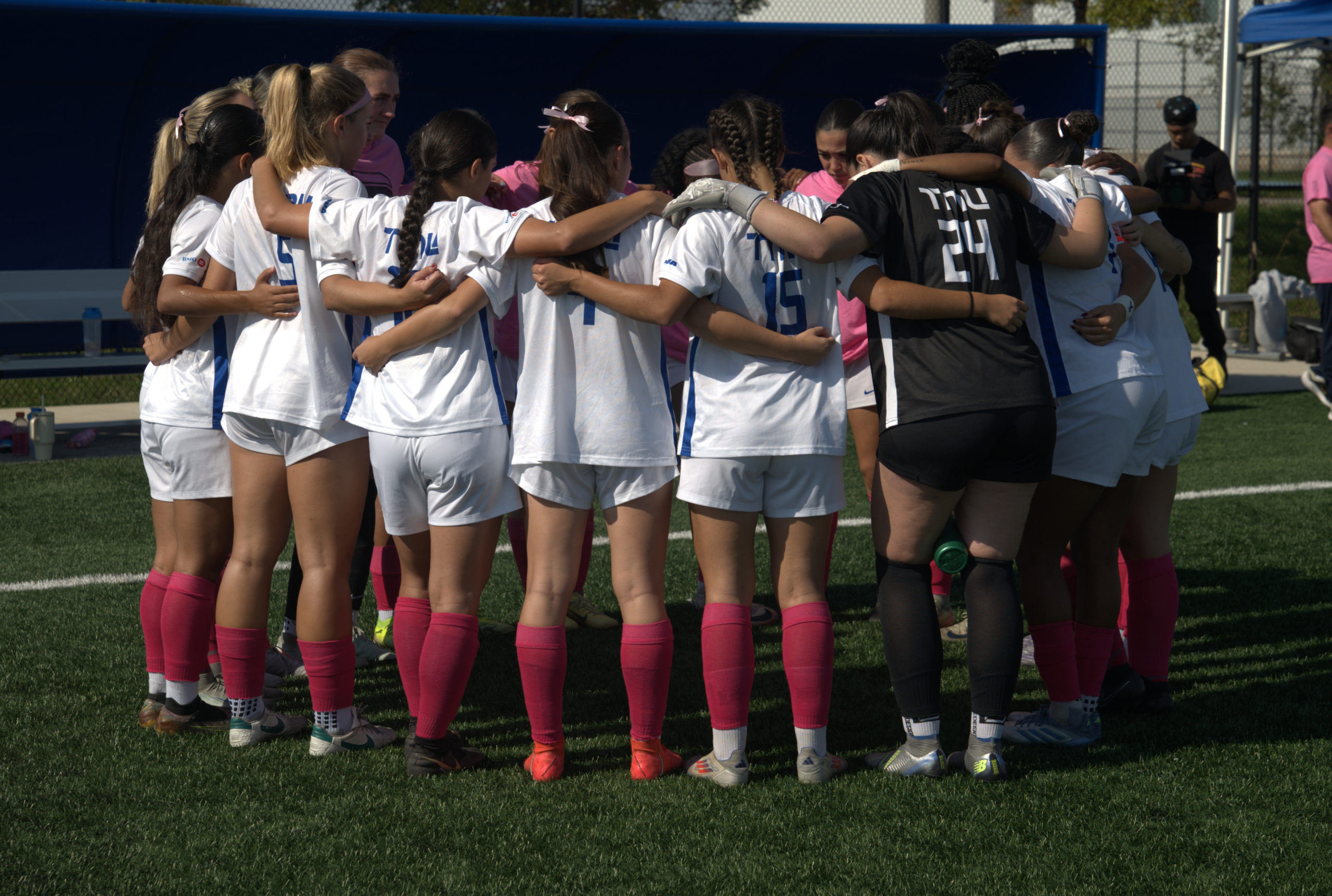 TMU huddles together before the game