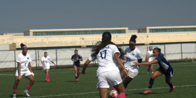 TMU gains possession of the ball amidst Laurentian defenders