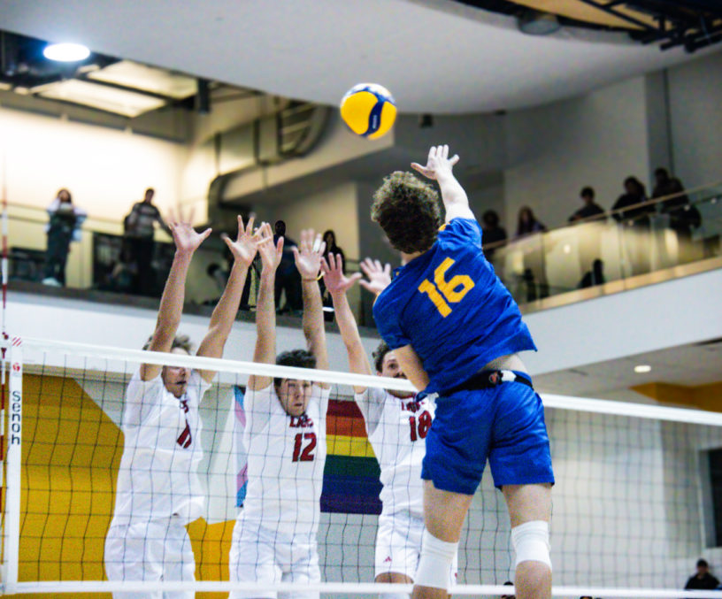 Kai Taylor going up for a hit against three York defenders