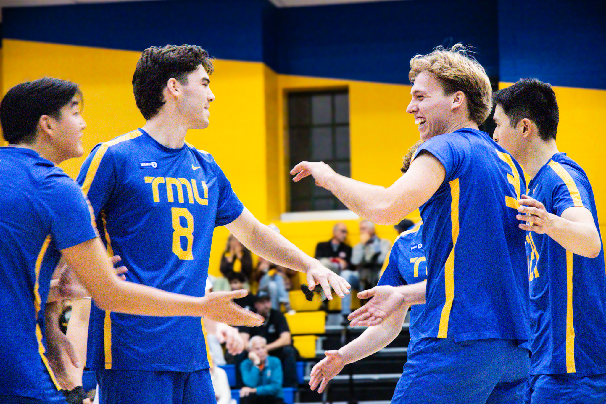 TMU men's volayball team celebrating a play